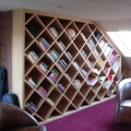 Attic library with diamond shaped shelves in oak