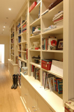 Large hallway library with storage cupboards - view 1