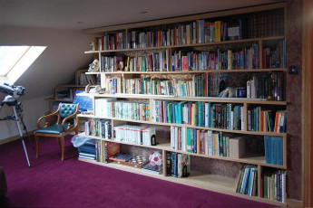 Attic library in oak wrapping around three walls