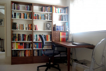 Bespoke home study with desk and shelves in walnut