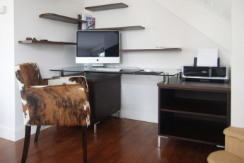 Bespoke desk with glass top and floating shelves in wenge